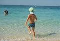 Portrait smiling little baby boy playing in the sea, ocean. Positive human emotions, feelings, joy. Funny cute child making vacati Royalty Free Stock Photo