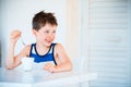 Portrait of smiling little boy refuses to eat delicious yogurt Royalty Free Stock Photo