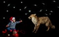 Portrait of smiling little boy wearing christmas hat sitting near vintage red telephone petting a fox on black background Royalty Free Stock Photo