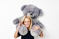 Portrait of a smiling little cutie with teddy bear a toy posing studio Royalty Free Stock Photo