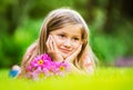 Portrait of a smiling little girl lying on green grass Royalty Free Stock Photo