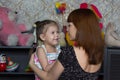 Portrait of smiling little girl and mother looking at each other with soft look and love