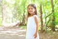 Portrait of smiling little girl walking in the forest Royalty Free Stock Photo