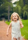 Portrait of smiling little girl walking in park Royalty Free Stock Photo