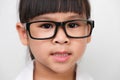 Portrait of a smiling little girl wearing glasses in a doctor or science costume on a white background. Little scientist Royalty Free Stock Photo