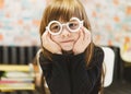 Portrait of a smiling little pretty girl in plastic glasses. A happy, cute little baby girl in fashionable white toy glasses poses