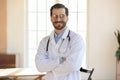 Portrait of smiling male Caucasian doctor posing at workplace Royalty Free Stock Photo