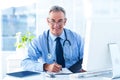 Portrait of smiling male doctor with document in hospital Royalty Free Stock Photo