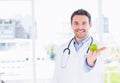 Portrait of a smiling male doctor holding an apple Royalty Free Stock Photo