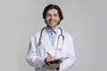 Portrait of smiling male doctor holding clipboard and taking patients history Royalty Free Stock Photo