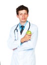 Portrait of a smiling male doctor holding green apple on white Royalty Free Stock Photo