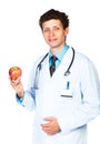 Portrait of a smiling male doctor holding red apple Royalty Free Stock Photo