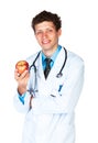 Portrait of a smiling male doctor holding red apple on white Royalty Free Stock Photo