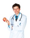 Portrait of a smiling male doctor holding red apple on white Royalty Free Stock Photo