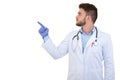 Portrait of a smiling male doctor pointing finger away isolated on a white background Royalty Free Stock Photo