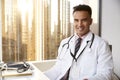 Portrait Of Smiling Male Doctor Wearing White Coat With Stethoscope In Hospital Office Royalty Free Stock Photo