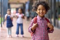 Portrait Of Smiling Male Elementary School Pupil Outdoors With Backpack At School Royalty Free Stock Photo