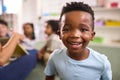 Portrait Of Smiling Male Elementary School Pupil Sitting In Classroom At  School Royalty Free Stock Photo