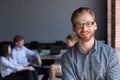 Portrait of smiling male employee posing during company briefing