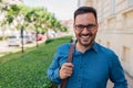 Portrait of smiling male entrepreneur carrying bag while standing in city Royalty Free Stock Photo