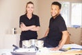 Portrait of smiling male and female decorators Royalty Free Stock Photo
