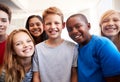 Portrait Of Smiling Male And Female Students In Grade School Classroom