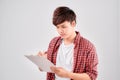 Portrait of smiling male handyman writing on clipboard over white background Royalty Free Stock Photo