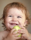 Portrait of smiling male kid with apple. Baby eating, cute child eat. Royalty Free Stock Photo