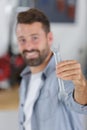 Portrait smiling male mechanic showing spanner Royalty Free Stock Photo