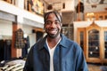 Portrait Of Smiling Male Owner Of Fashion Store Standing In Front Of Clothing Display