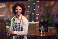 Portrait Of Smiling Male Server Clearing Table In Cool Bar Or Club