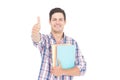 Portrait of smiling male student holding books and showing thumbs up Royalty Free Stock Photo