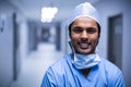 Portrait of smiling male surgeon standing in corridor Royalty Free Stock Photo