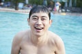 Portrait of smiling man exiting the pool and looking at camera