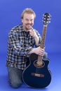 Portrait Of A Smiling Man With Guitar Royalty Free Stock Photo