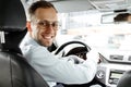 Portrait of smiling man in his car. Business taxi driver. Looking camera. saloon view Royalty Free Stock Photo