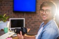 Portrait of smiling man holding camera Royalty Free Stock Photo