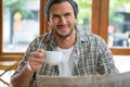 Portrait of smiling man holding coffee cup in cafe Royalty Free Stock Photo