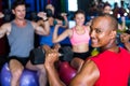 Portrait of smiling man holding dumbbell in gym Royalty Free Stock Photo