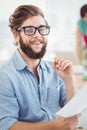 Portrait of smiling man holding pen and paper Royalty Free Stock Photo