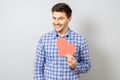 Portrait of smiling man holding red paper pixel heart Royalty Free Stock Photo