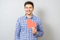Portrait of smiling man holding red paper pixel heart Royalty Free Stock Photo