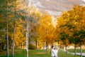 Portrait of smiling man hugging woman with wreath of yellow leaves in autumn forest Royalty Free Stock Photo