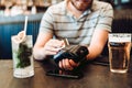 Portrait of smiling man paying by credit card at restaurant bar Royalty Free Stock Photo