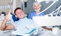 Portrait of smiling man visiting dentist giving thumbs up Royalty Free Stock Photo