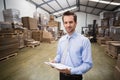 Portrait of smiling manager holding clipboard