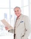 Portrait of a smiling manager reading newspaper Royalty Free Stock Photo