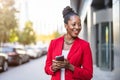 Smiling mature businesswoman using mobile phone in urban setting Royalty Free Stock Photo