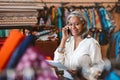 Smiling woman talking on a cellphone in her fabric shop Royalty Free Stock Photo