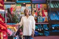 Mature woman smiling while working in her fabric shop Royalty Free Stock Photo